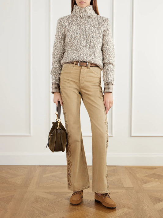 Image of a model wearing Pants. Product name - Floral-embroidered Cotton Flared Pants in Tan colour by brand - RRL