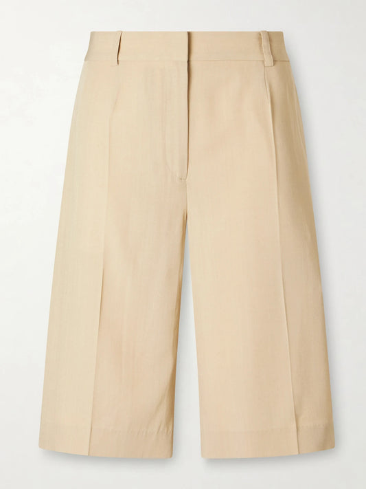 Image of a model wearing Shorts. Product name - Woven Shorts in Beige colour by brand - TOTEME