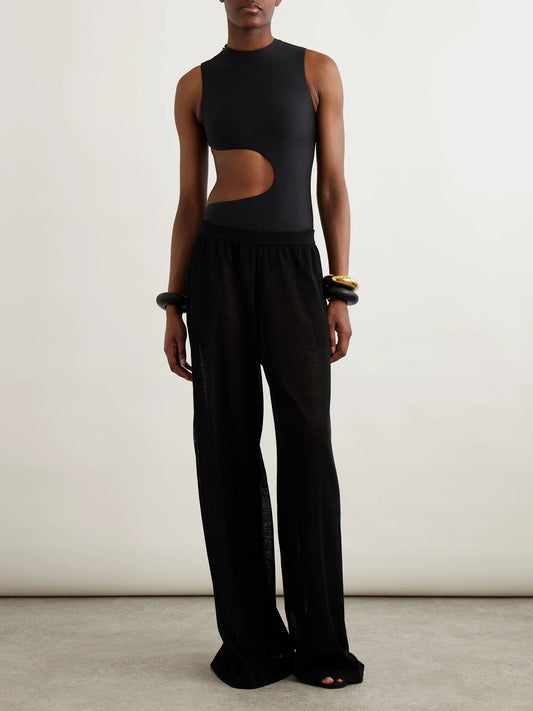 Image of a model wearing Pants. Product name - Linen And Silk-blend Wide-leg Pants in Black colour by brand - Alaïa