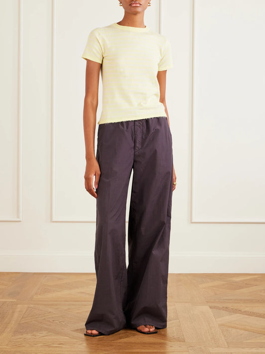 Image of a model wearing Tops. Product name - Knitted Striped Cotton T-shirt in Yellow colour by brand - Auralee