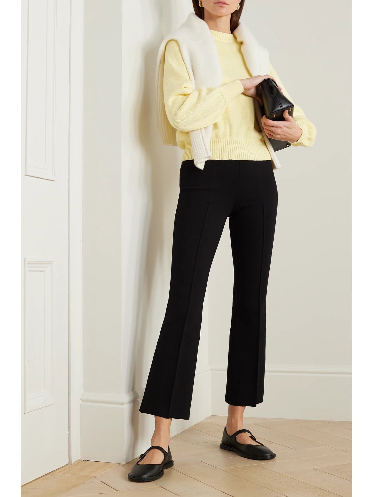 Image of a model wearing Pants. Product name - Kick Cropped Stretch-cotton Flared Pants in Black colour by brand - HIGH SPORT