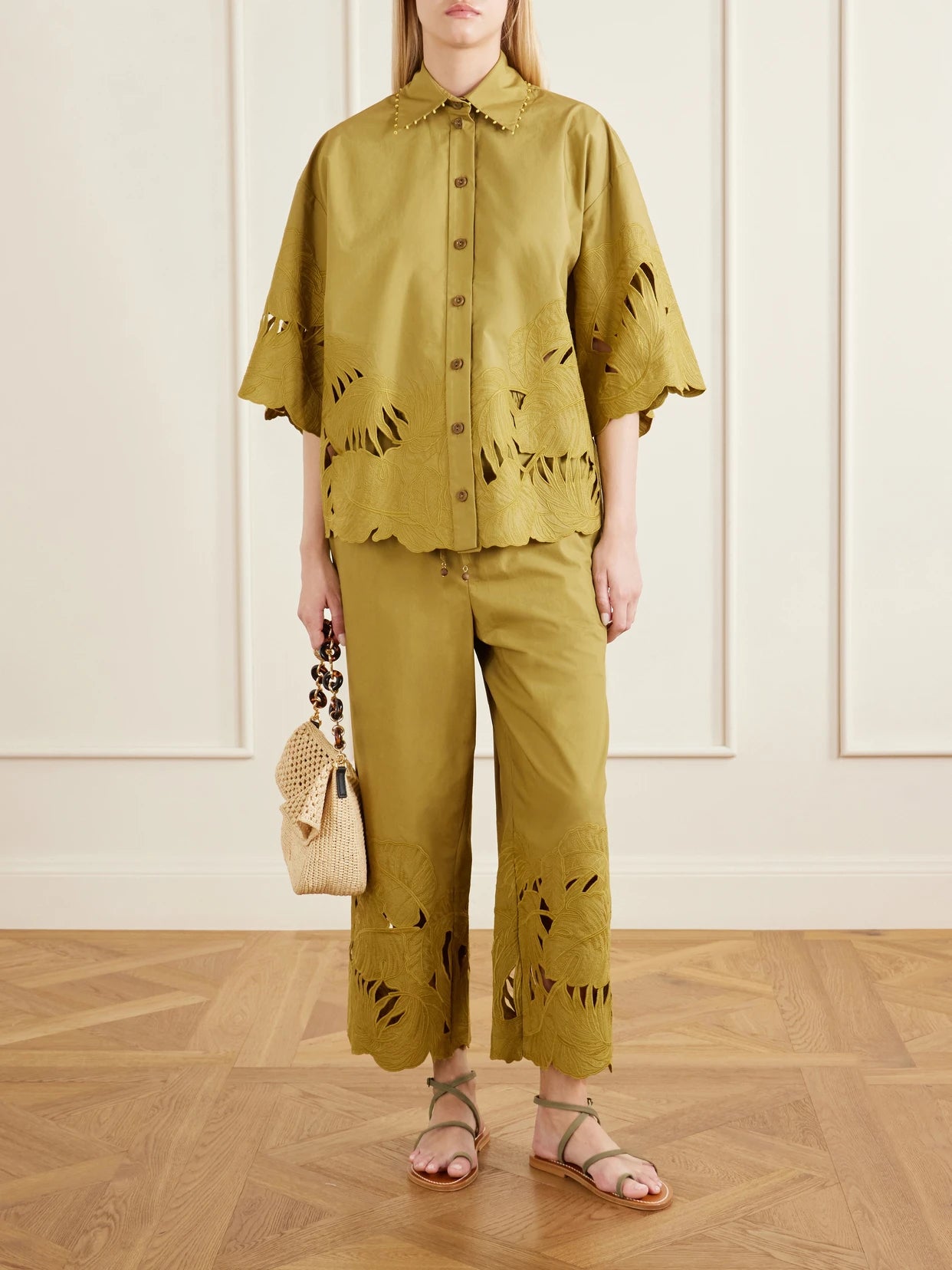 Image of a model wearing Pants. Product name - Mahon Embroidered Cotton Wide-leg Pants in Green colour by brand - Zimmermann