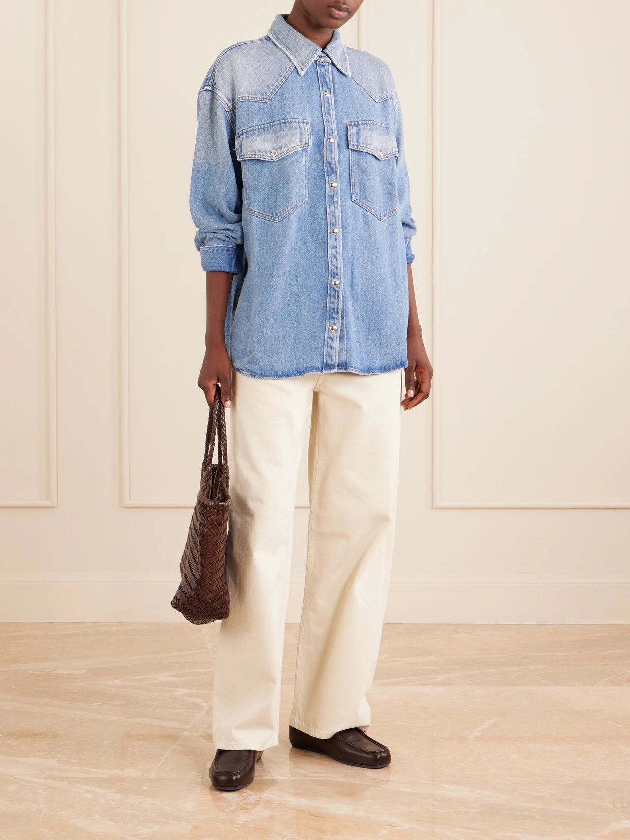 Image of a model wearing Tops. Product name - Lotta Denim Shirt in Mid denim colour by brand - AGOLDE