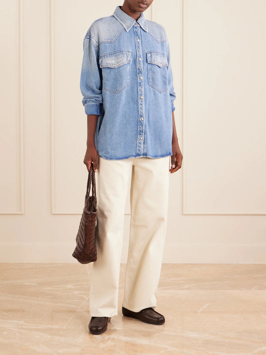 Image of a model wearing Tops. Product name - Lotta Denim Shirt in Mid denim colour by brand - AGOLDE