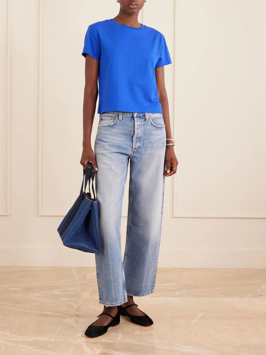 Image of a model wearing Tops. Product name - Adine Cropped Organic Cotton-jersey T-shirt in Cobalt blue colour by brand - AGOLDE