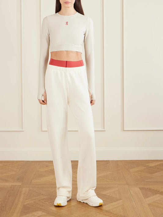 Image of a model wearing Tops. Product name - Year Of The Horse Cropped Mesh-trimmed Stretch Recycled Top in Ivory colour by brand - ON
