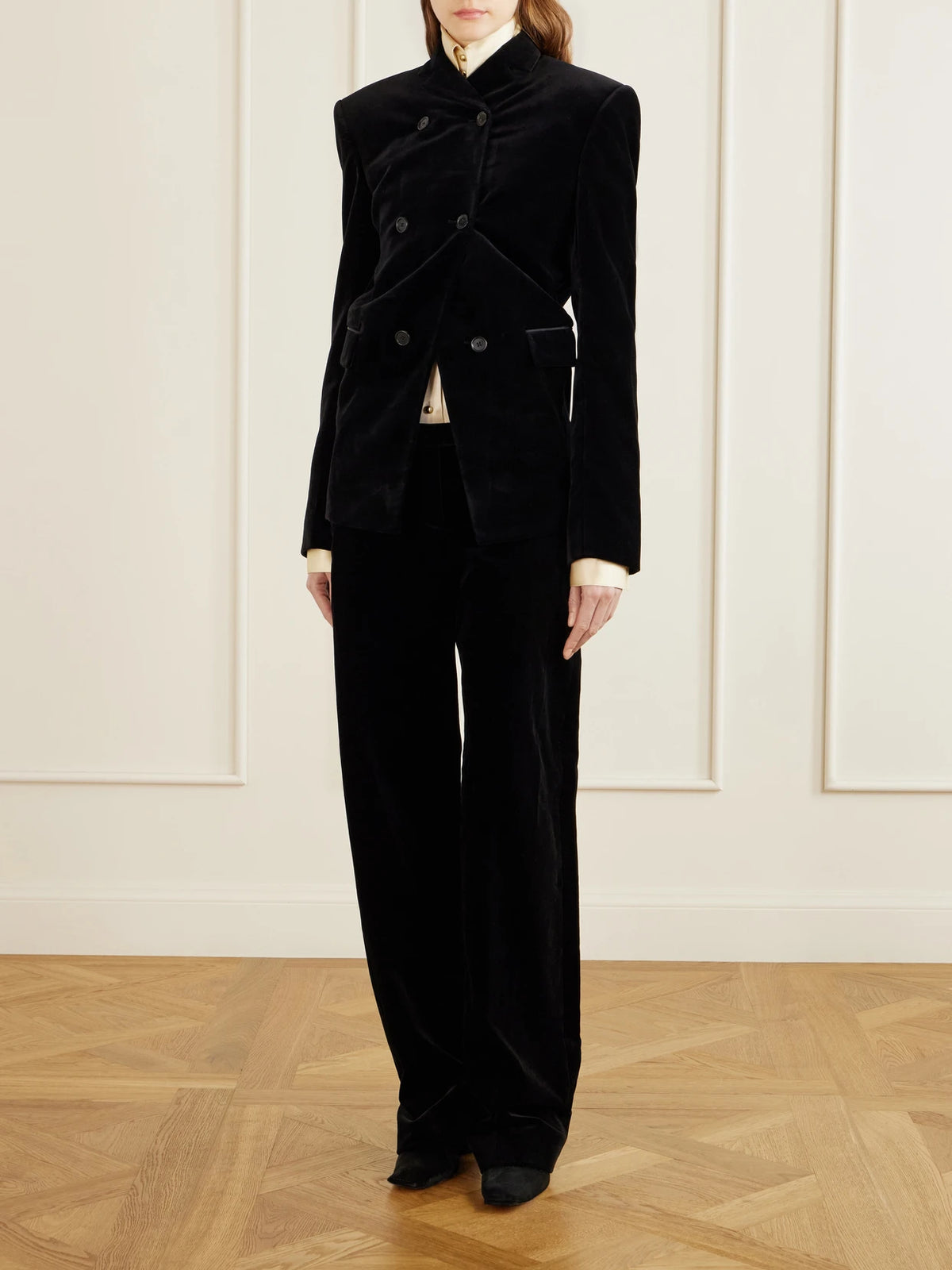 Image of a model wearing Pants. Product name - Hunter Cotton-blend Velvet Straight-leg Pants in Black colour by brand - KHAITE
