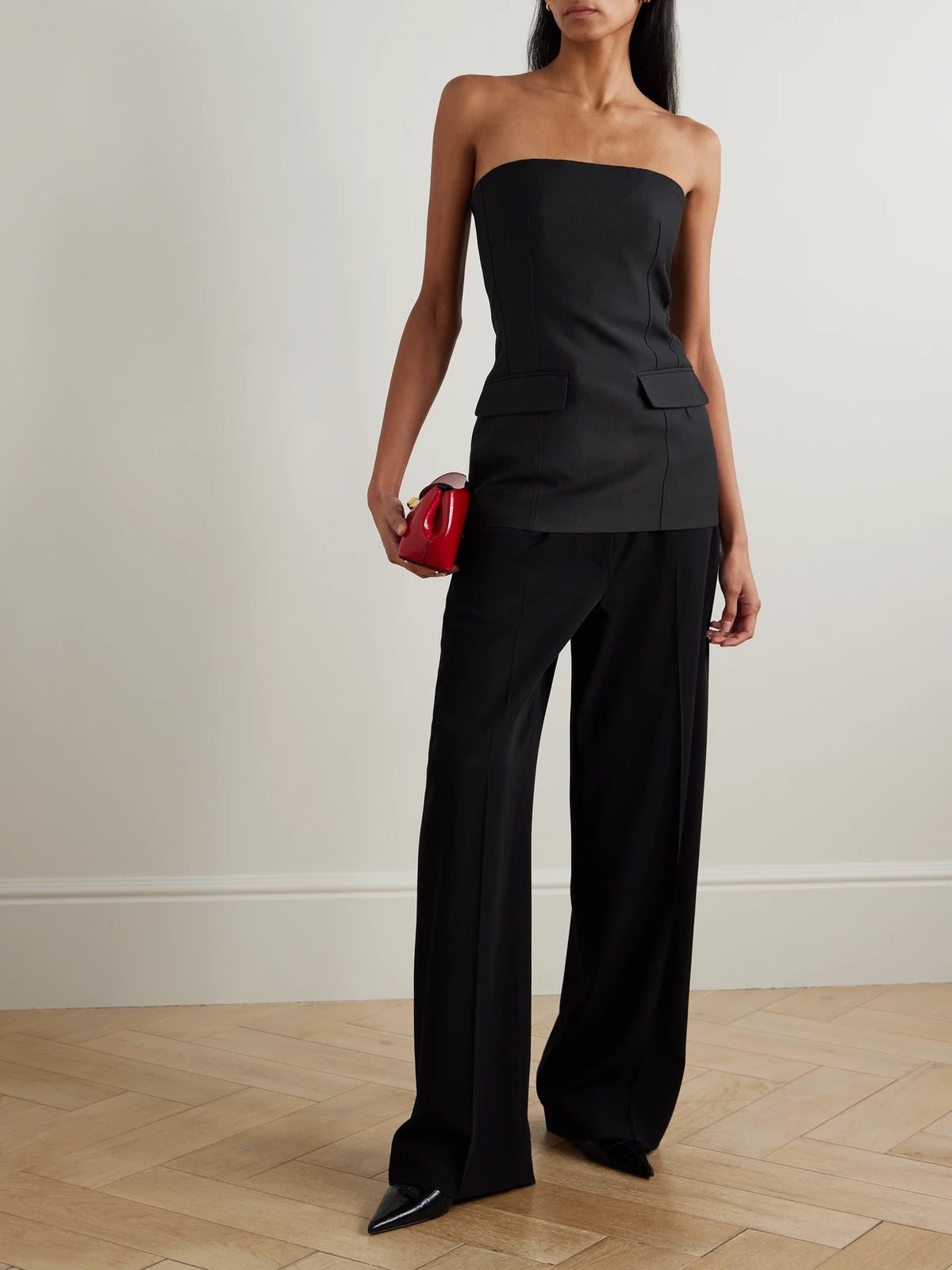 Image of a model wearing Tops. Product name - Strapless Wool And Silk-blend Bustier Top in Black colour by brand - TOTEME