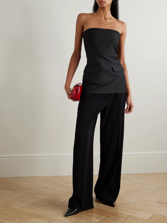 Image of a model wearing Tops. Product name - Strapless Wool And Silk-blend Bustier Top in Black colour by brand - TOTEME