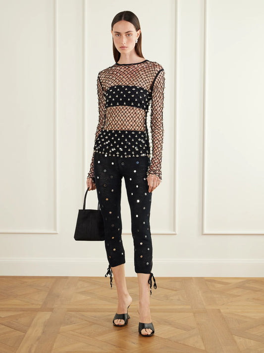 Image of a model wearing Pants. Product name - Tanvee Embellished Cotton Crochet-knit Skinny Capri Pants in Black colour by brand - Yoshita 1967