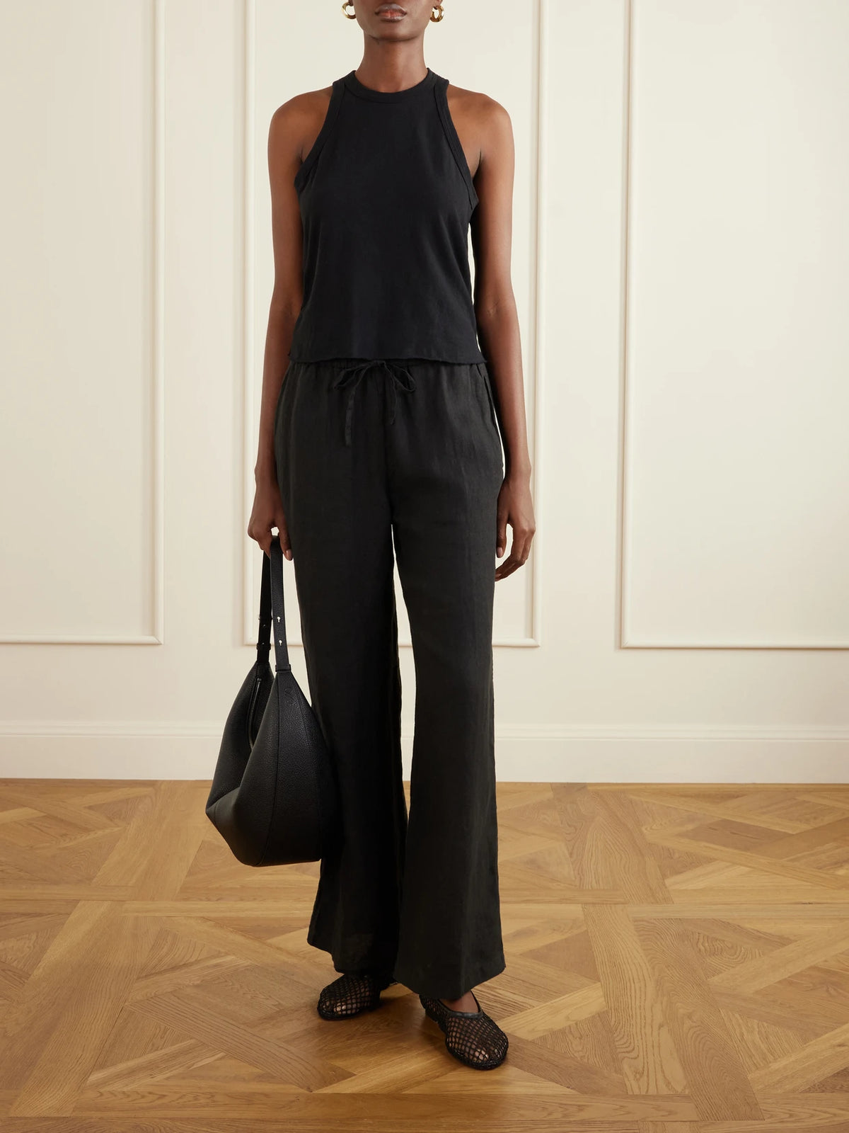 Image of a model wearing Tops. Product name - Slub Cotton-jersey Tank Top in Black colour by brand - James Perse