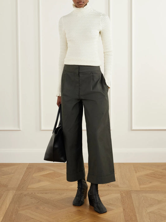 Image of a model wearing Outerwear. Product name - Juniper Turtleneck Cable-knit Cotton-blend Sweater in Cream colour by brand - Proenza Schouler White Label