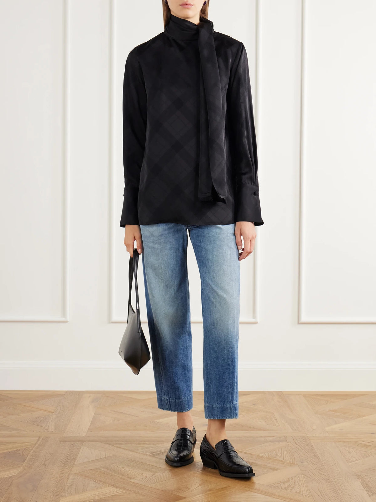 Image of a model wearing Tops. Product name - The Luss Tie-detailed Checked Satin Blouse in Black colour by brand - RÙADH