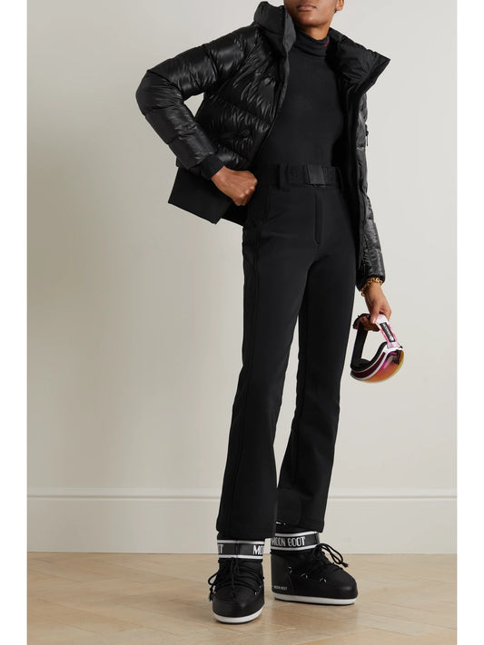 Image of a model wearing Pants. Product name - Pippa Belted Flared Ski Pants in Black colour by brand - Goldbergh