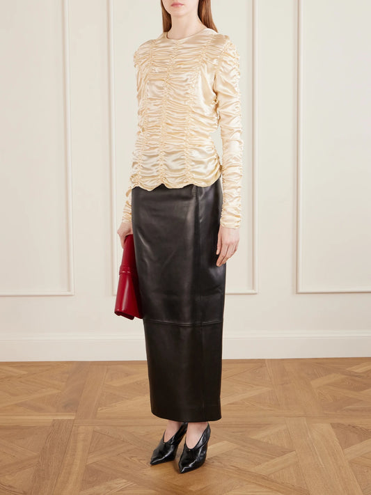 Image of a model wearing Tops. Product name - Rory Ruched Silk Top in Ecru colour by brand - KHAITE