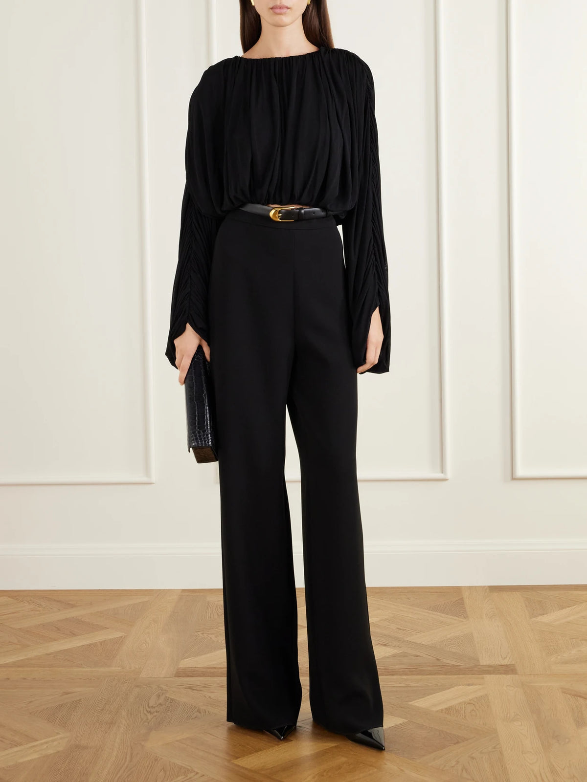 Image of a model wearing Tops. Product name - Micka Jersey Draped Blouse in Black colour by brand - Heirlome