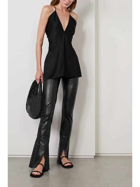 Image of a model wearing Pants. Product name - Spat Vegan Leather Flared Leggings in Black colour by brand - Norma Kamali