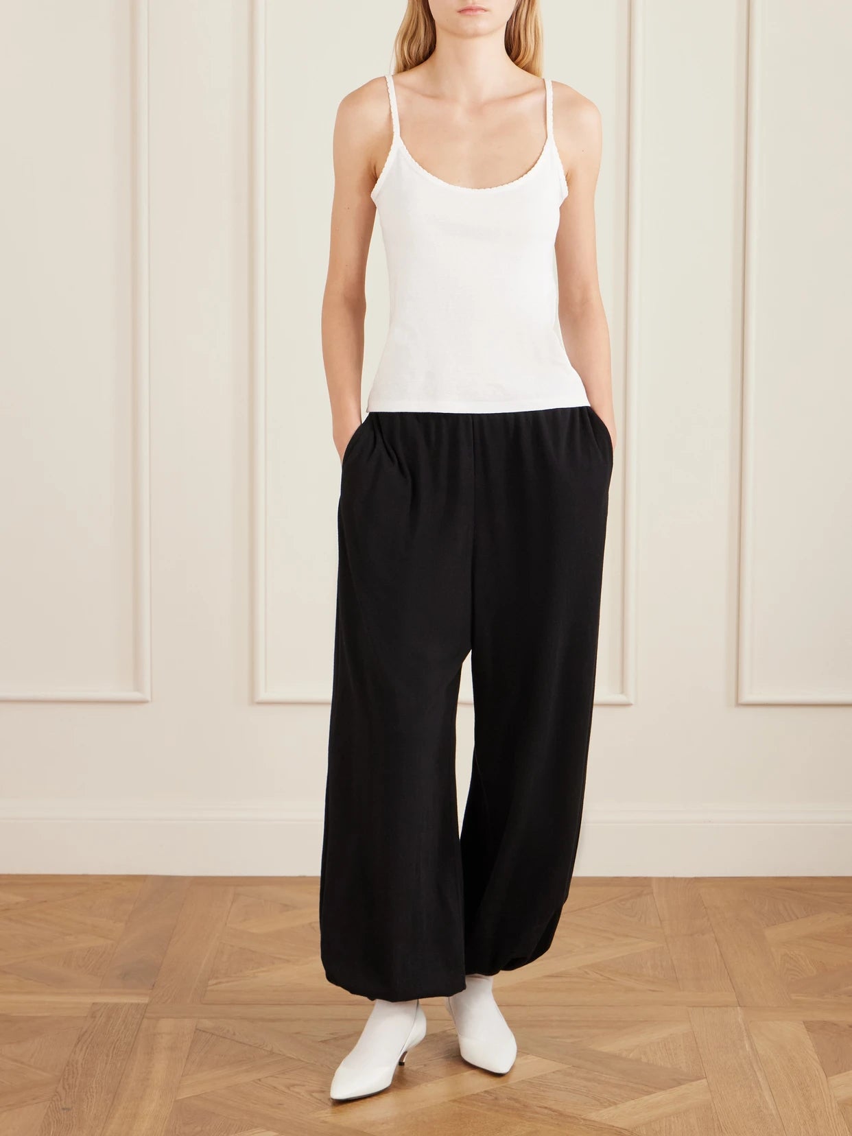 Image of a model wearing Tops. Product name - Denzel Ribbed Cotton-jersey Tank in White colour by brand - The Row