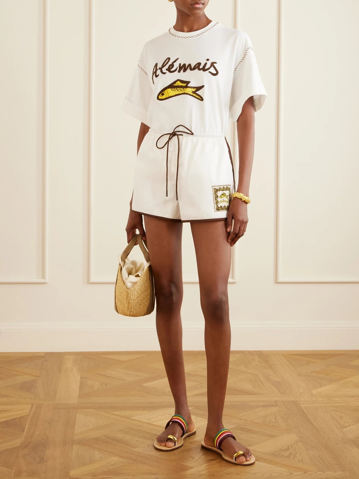 Image of a model wearing Shorts. Product name - Scuba Embroidered Cotton-poplin Shorts in Ivory colour by brand - ALÉMAIS