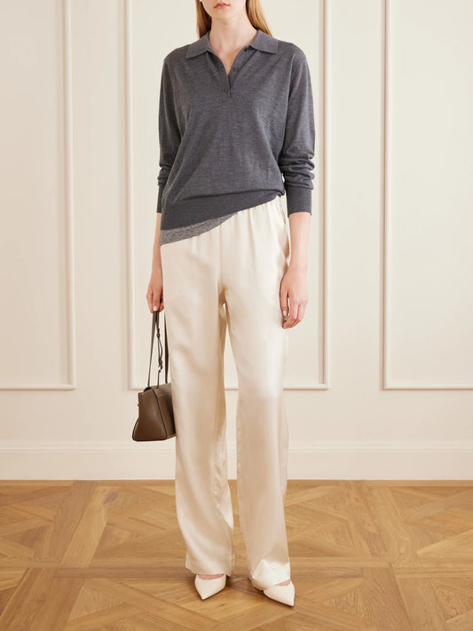 Image of a model wearing Pants. Product name - Alera Silk Wide-leg Pants in Cream colour by brand - Loulou de Saison