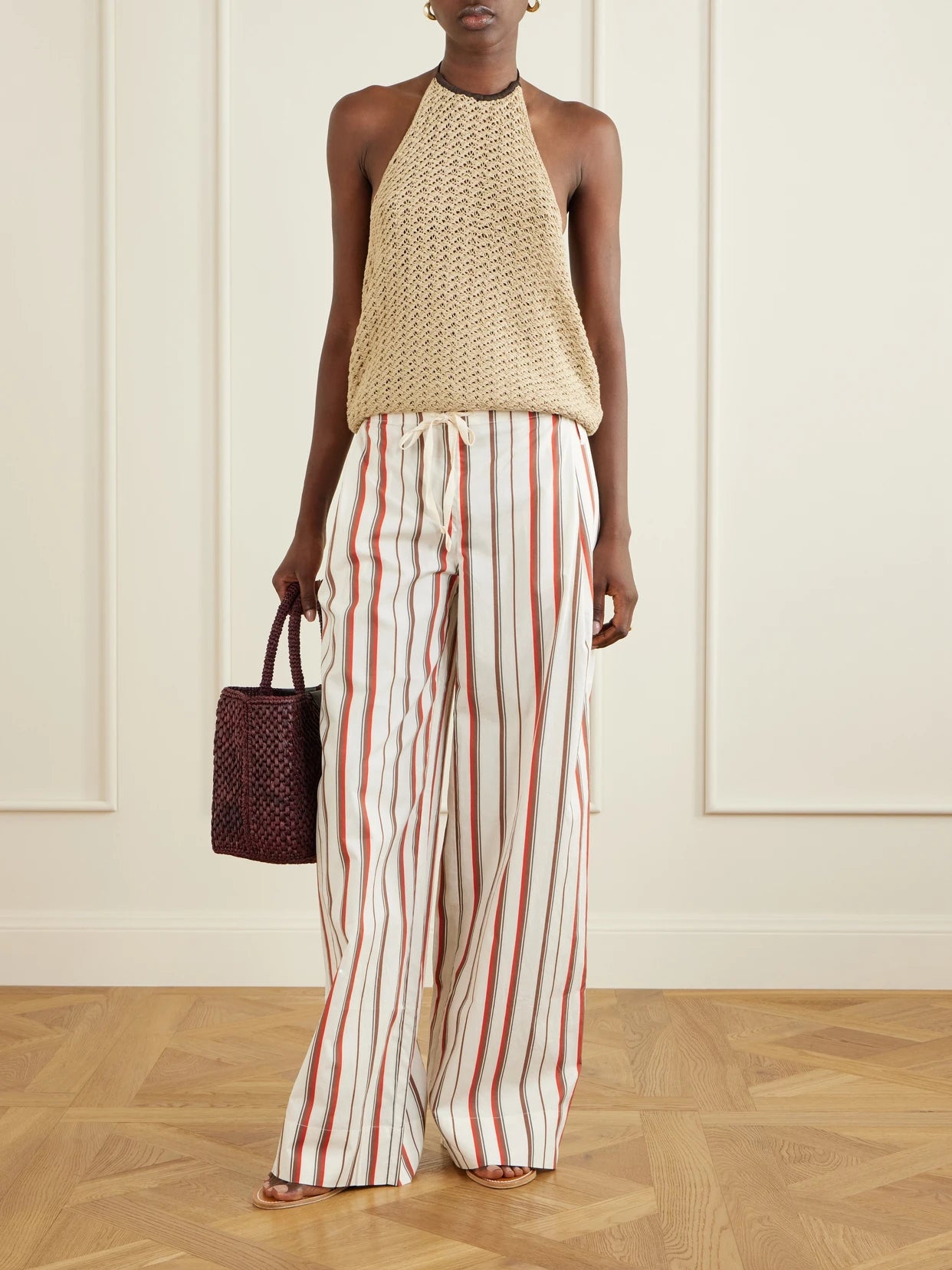 Image of a model wearing Pants. Product name - Alva Striped Cotton Wide-leg Pants in Red colour by brand - SIR.