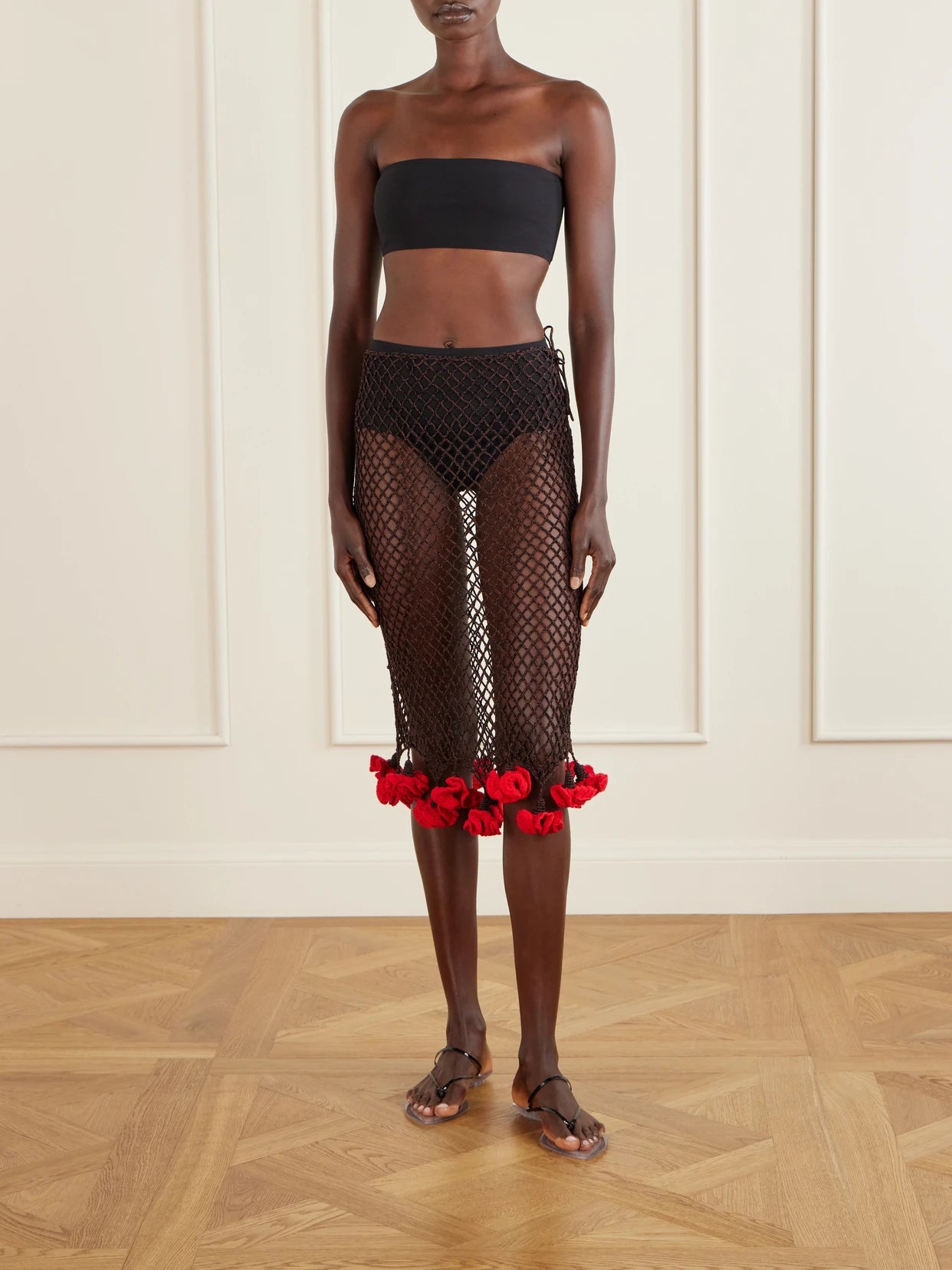 Image of a model wearing Skirts. Product name - Embellished Crocheted Midi Skirt in Brown colour by brand - Alaïa