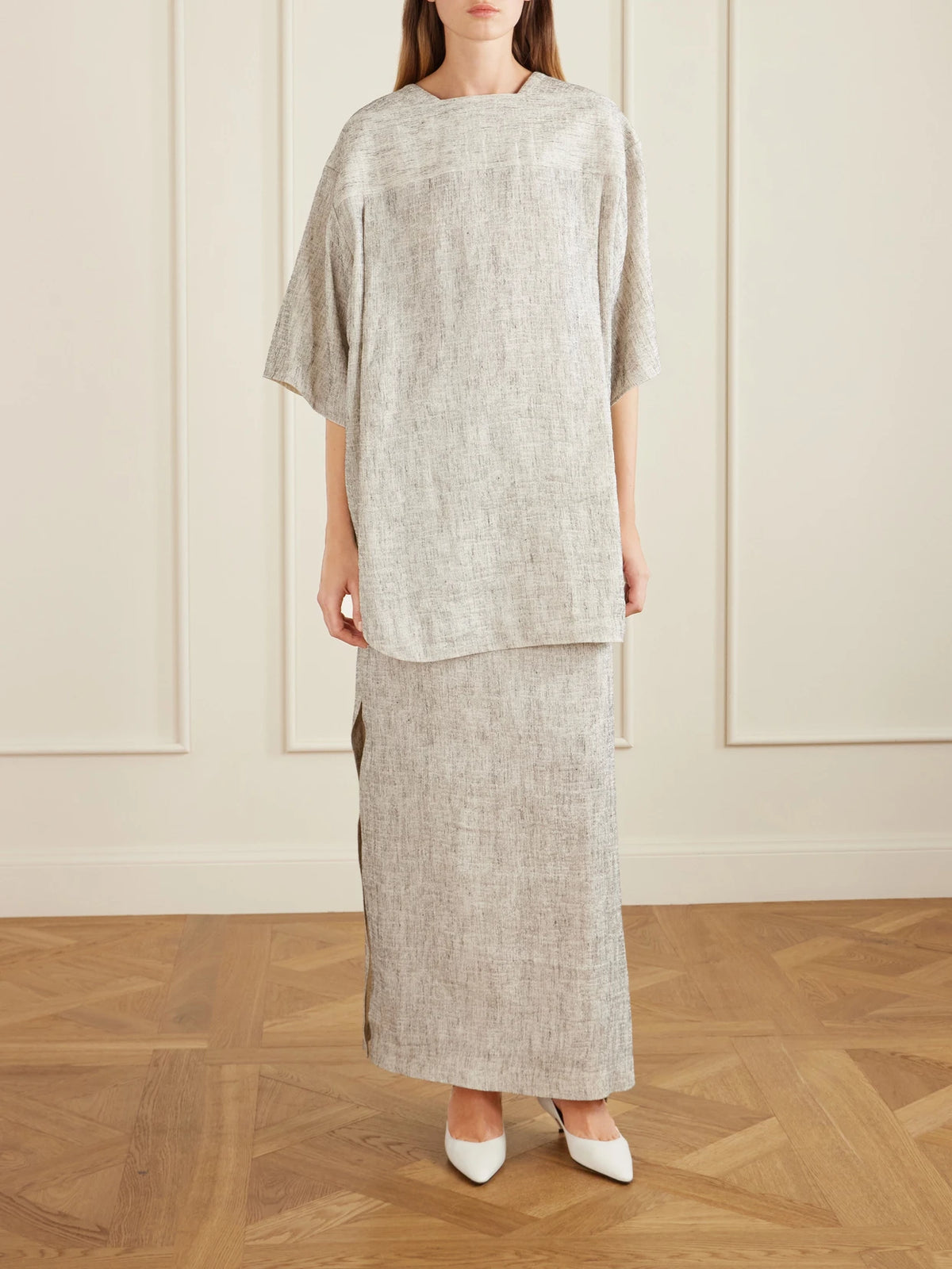 Image of a model wearing Tops. Product name - Hamza Oversized Linen And Silk-blend Top in Gray colour by brand - The Row