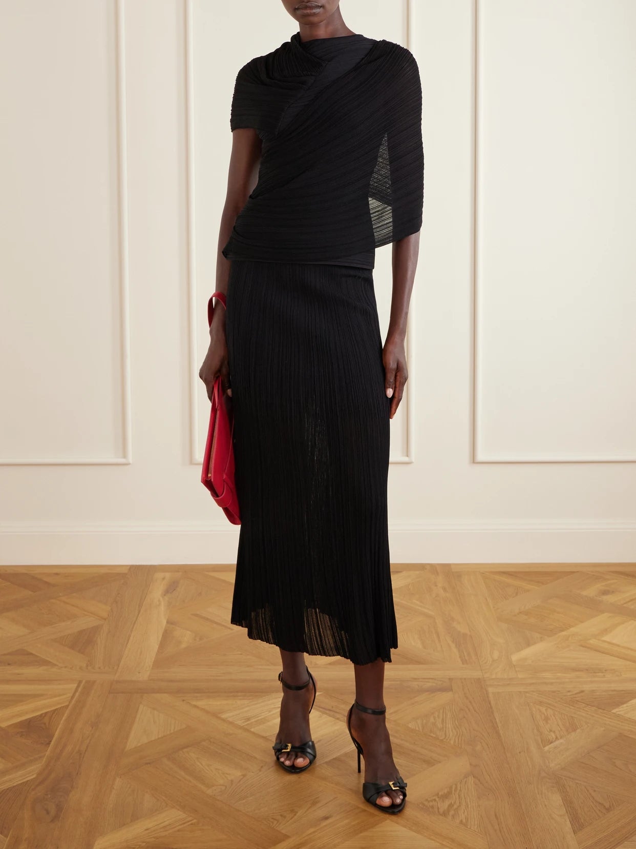 Image of a model wearing Skirts. Product name - Plissé-crepe Midi Skirt in Black colour by brand - Balmain