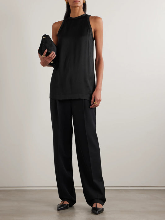 Image of a model wearing Pants. Product name - Pleated Twill Straight-leg Pants in Black colour by brand - TOTEME