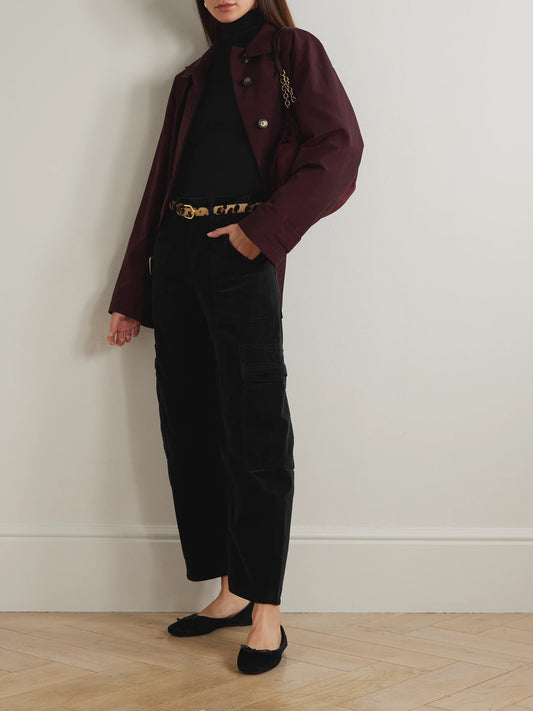 Image of a model wearing Tops. Product name - Caradene Ribbed Stretch-lyocell Turtleneck Sweater in Black colour by brand - Citizens of Humanity
