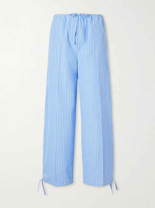 Image of a model wearing Pants. Product name - Striped Cotton Wide-leg Balloon Pants in Blue colour by brand - TOTEME