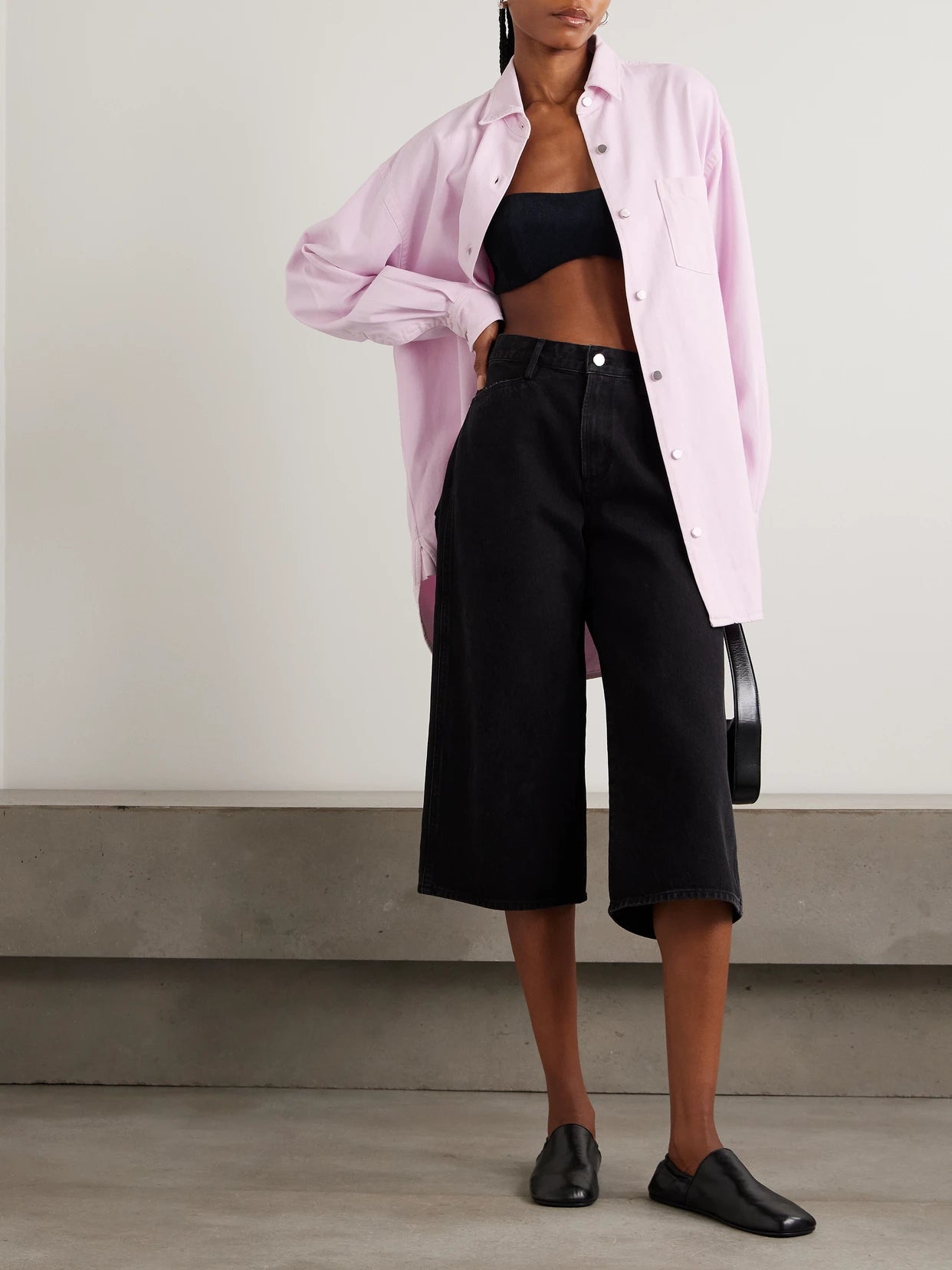 Image of a model wearing Tops. Product name - + Maria Mcmanus Oversized Organic Denim Shirt in Pastel pink colour by brand - AGOLDE