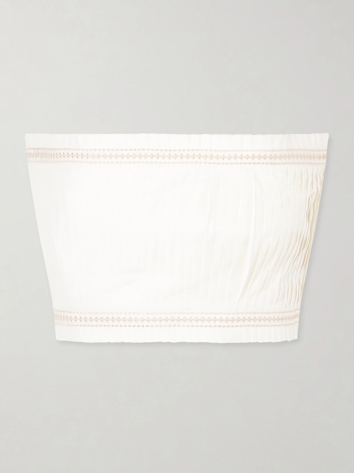 Image of a model wearing Tops. Product name - Flavia Strapless Cropped Embroidered Pleated Cotton-blend Top in White colour by brand - Emporio Sirenuse