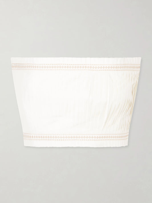Image of a model wearing Tops. Product name - Flavia Strapless Cropped Embroidered Pleated Cotton-blend Top in White colour by brand - Emporio Sirenuse