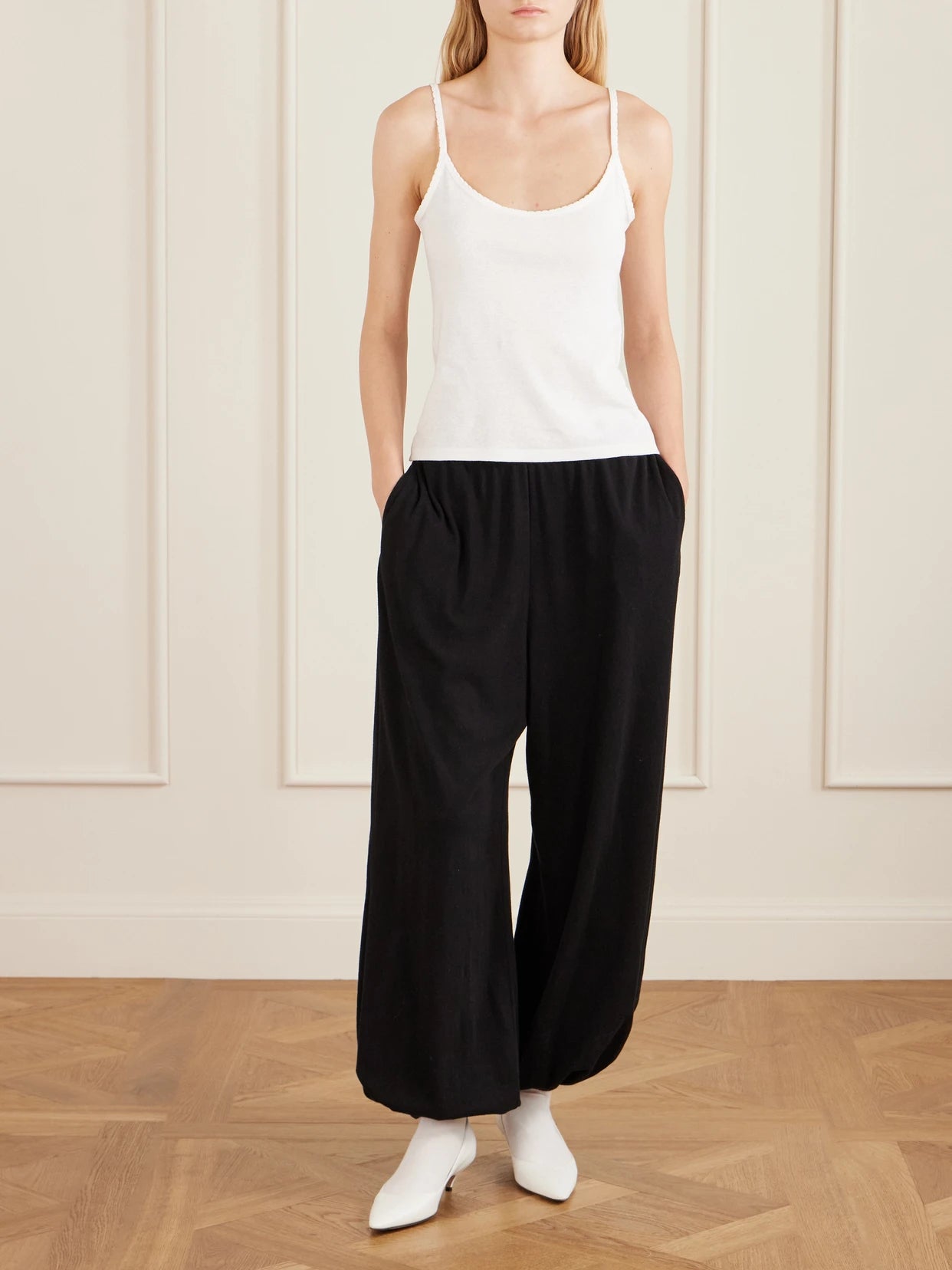 Image of a model wearing Pants. Product name - Fiamma Cotton, Cashmere And Silk-blend Balloon Pants in Black colour by brand - The Row