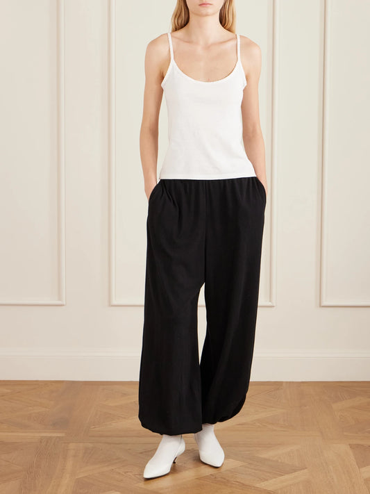 Image of a model wearing Pants. Product name - Fiamma Cotton, Cashmere And Silk-blend Balloon Pants in Black colour by brand - The Row