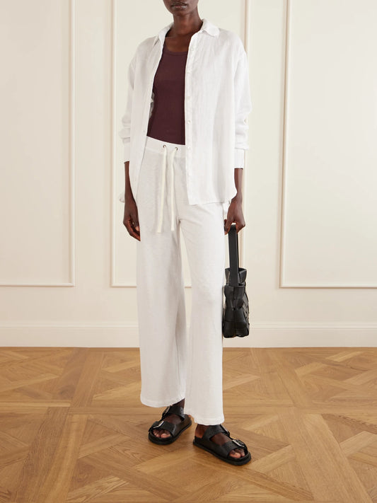 Image of a model wearing Tops. Product name - Ribbed Supima Cotton-blend Tank in Burgundy colour by brand - James Perse