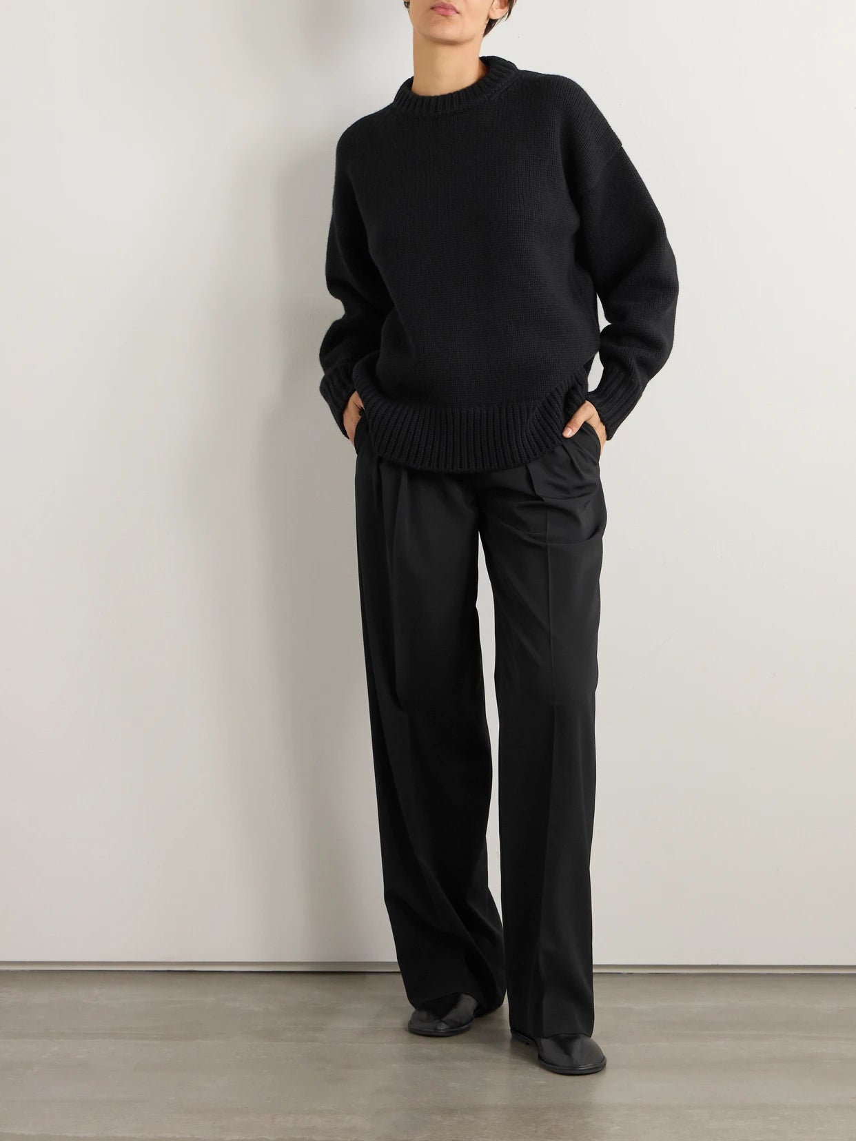 Image of a model wearing Outerwear. Product name - Essentials Ophelia Wool And Cashmere-blend Sweater in Black colour by brand - The Row