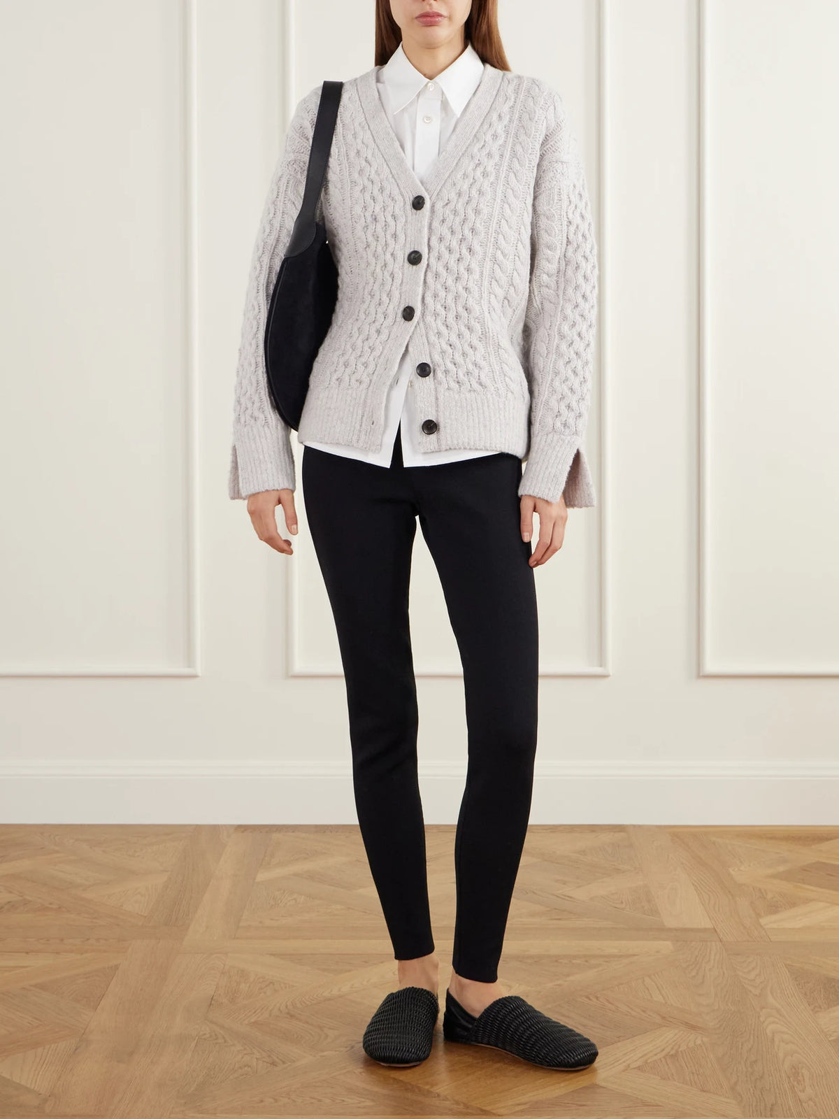 Image of a model wearing Outerwear. Product name - Cable-knit Wool And Cashmere-blend Cardigan in Off-white colour by brand - Maria McManus