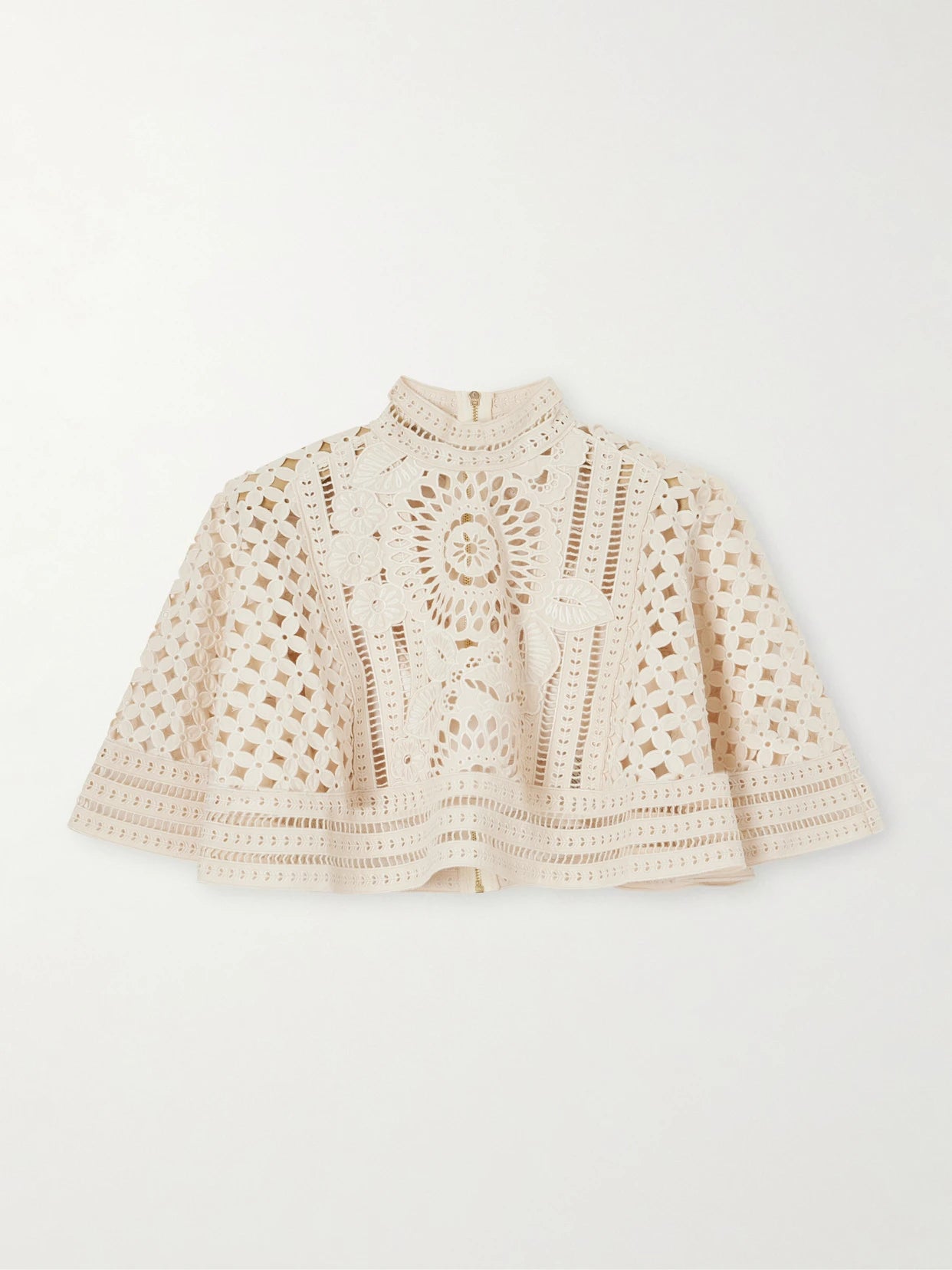 Image of a model wearing Tops. Product name - Indra Embroidered Cotton Cape in Cream colour by brand - Zimmermann