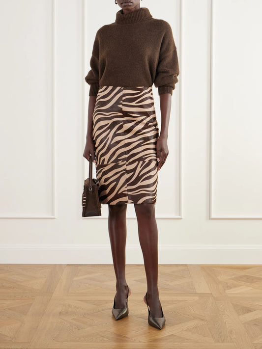 Image of a model wearing Skirts. Product name - Nathaly Paneled Zebra-print Calf-hair Knee-length Skirt in Zebra print colour by brand - ARMA