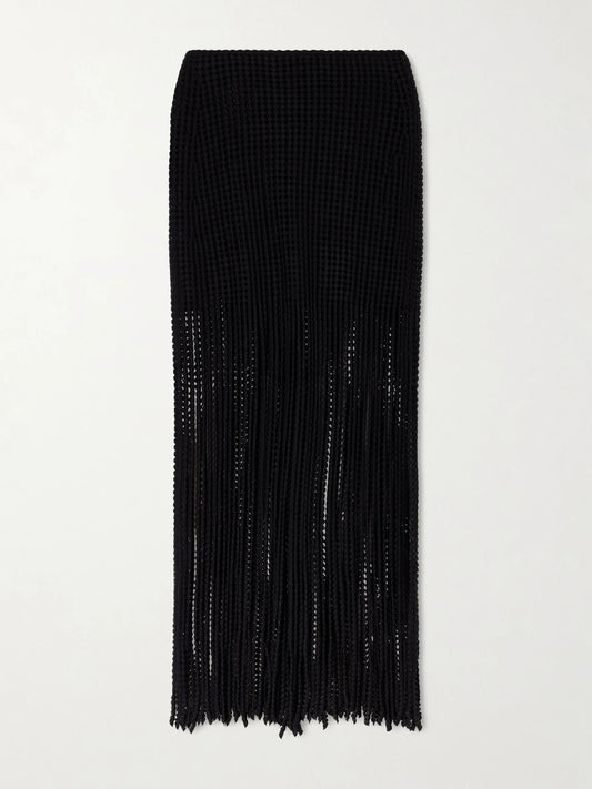 Image of a model wearing Skirts. Product name - Knitted Fringed Midi Skirt in Black colour by brand - Alaïa