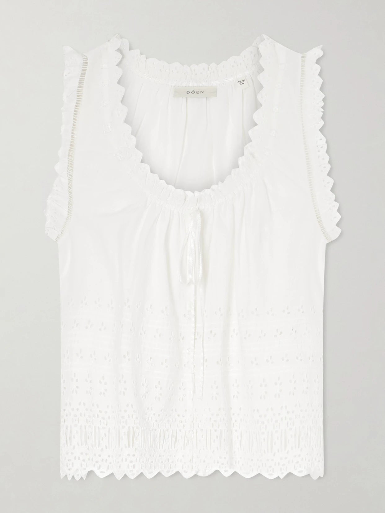 Image of a model wearing Tops. Product name - Toussine Gatehred Broderie Anglaise Cotton Top in White colour by brand - DÔEN
