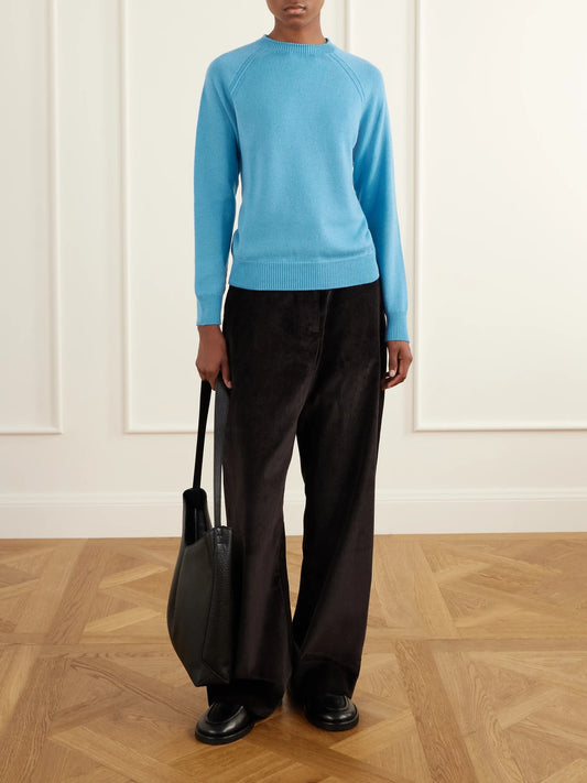 Image of a model wearing Outerwear. Product name - Loenne Merino Wool Sweater in Blue colour by brand - Studio Nicholson