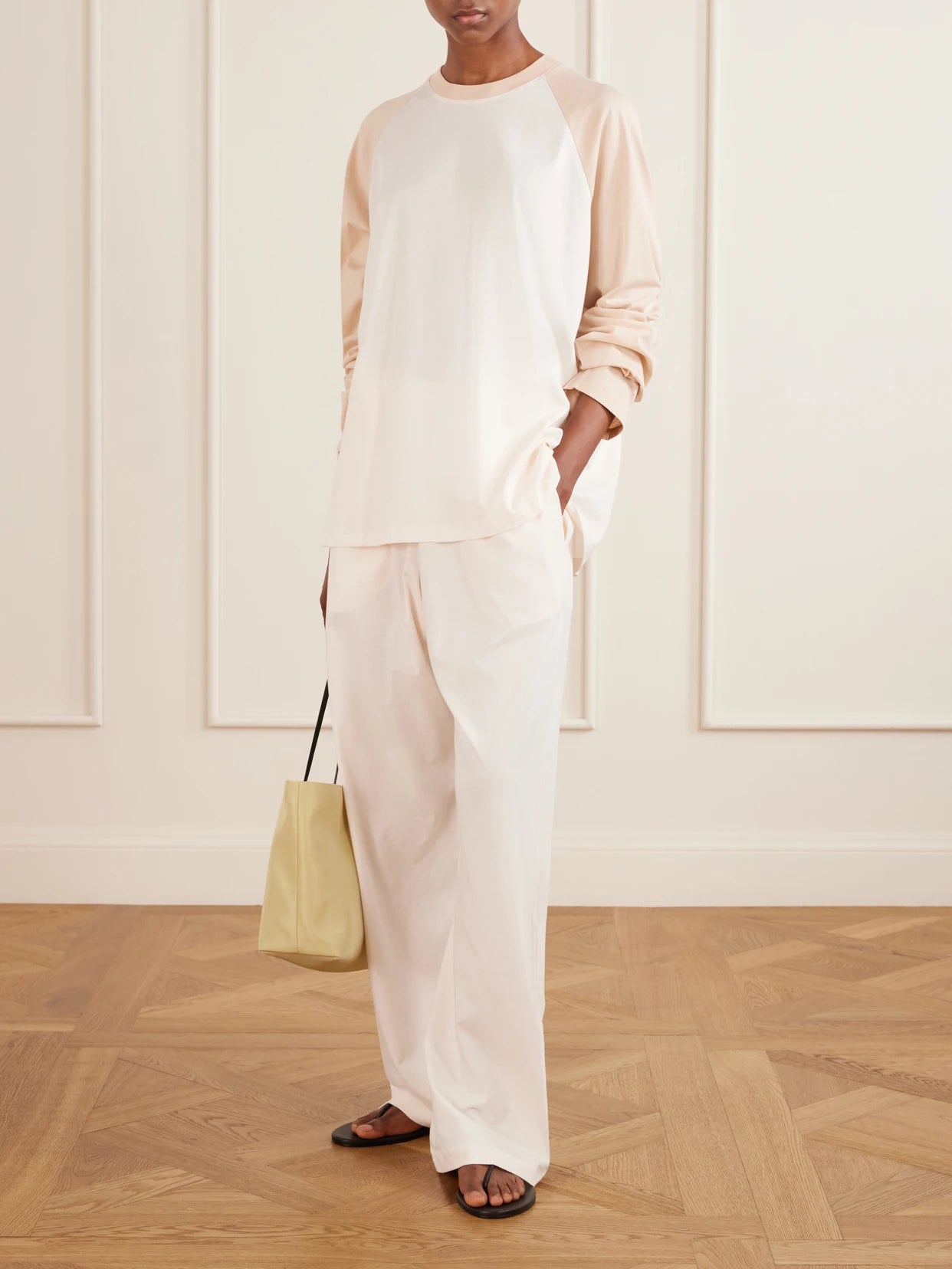 Image of a model wearing Pants. Product name - Cotton Pajama Wide-leg Pants in Blush colour by brand - WARDROBE. NYC