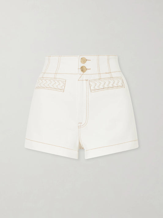Image of a model wearing Shorts. Product name - Roselight Denim Shorts in Cream colour by brand - Zimmermann