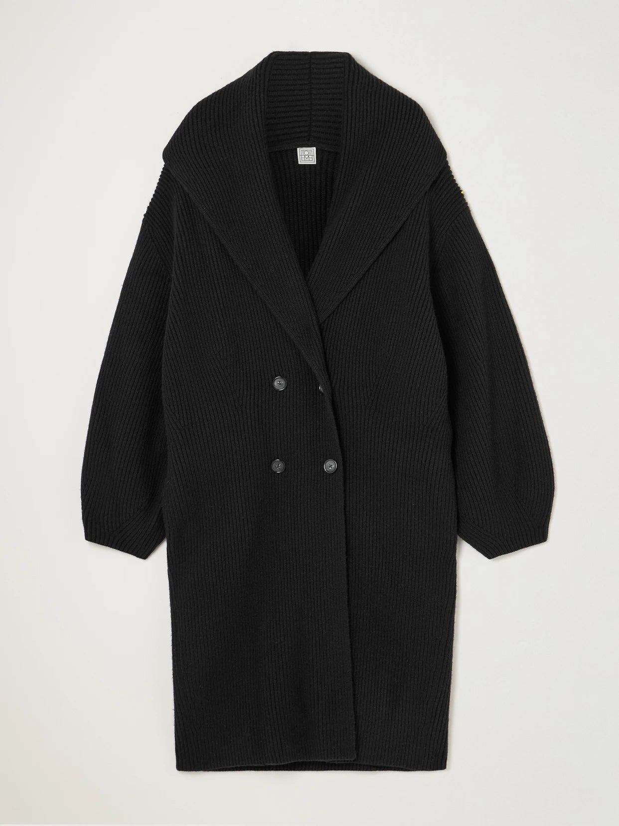Image of a model wearing Outerwear. Product name - Double-breasted Ribbed Wool Cardigan in Black colour by brand - TOTEME