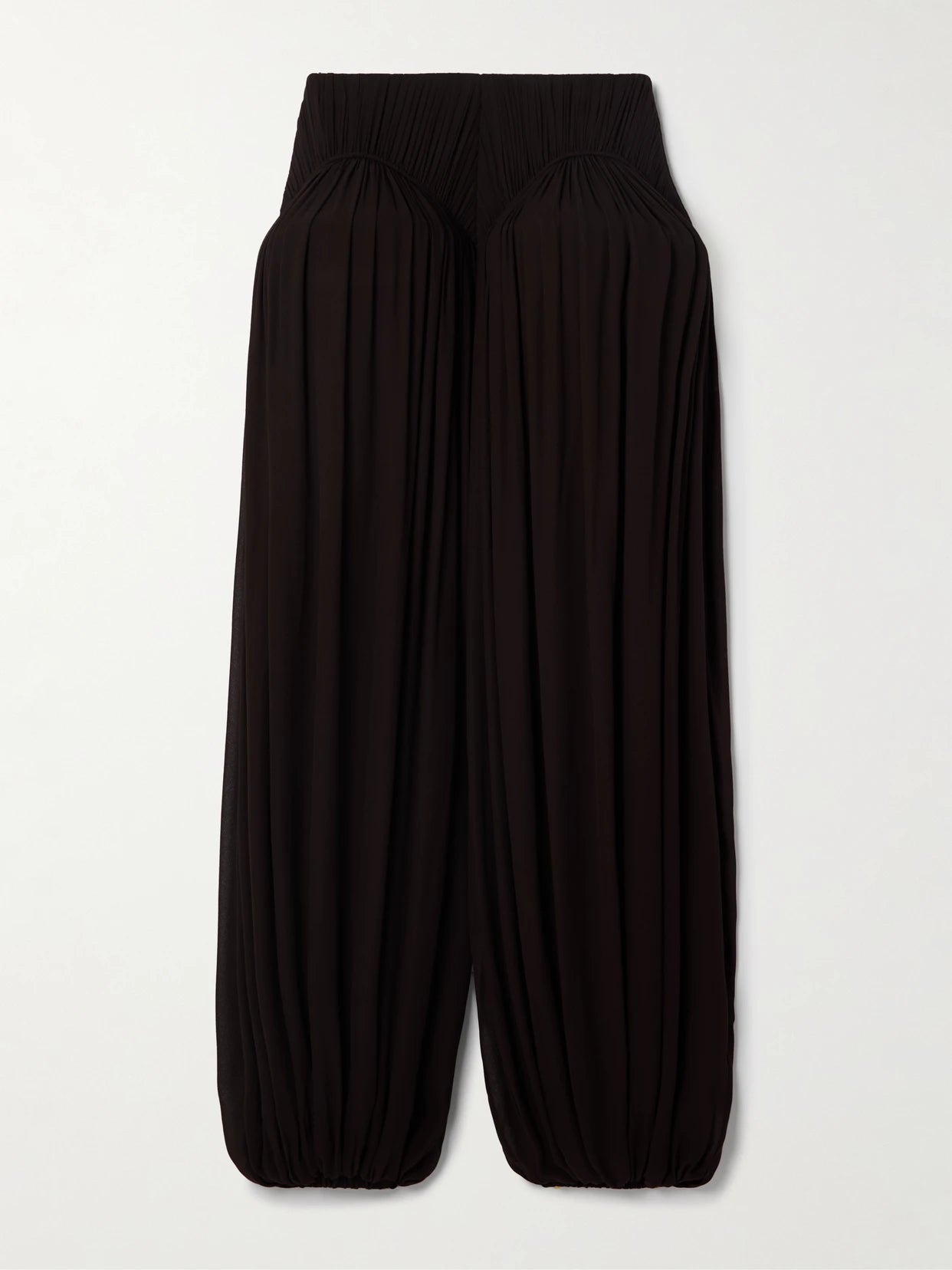 Image of a model wearing Pants. Product name - Pleated Crepe Balloon Pants in Dark brown colour by brand - Alaïa