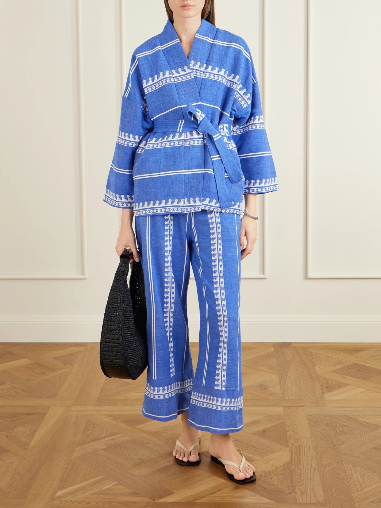 Image of a model wearing Pants. Product name - Desta Straight-leg Cotton Pants in Blue colour by brand - lemlem