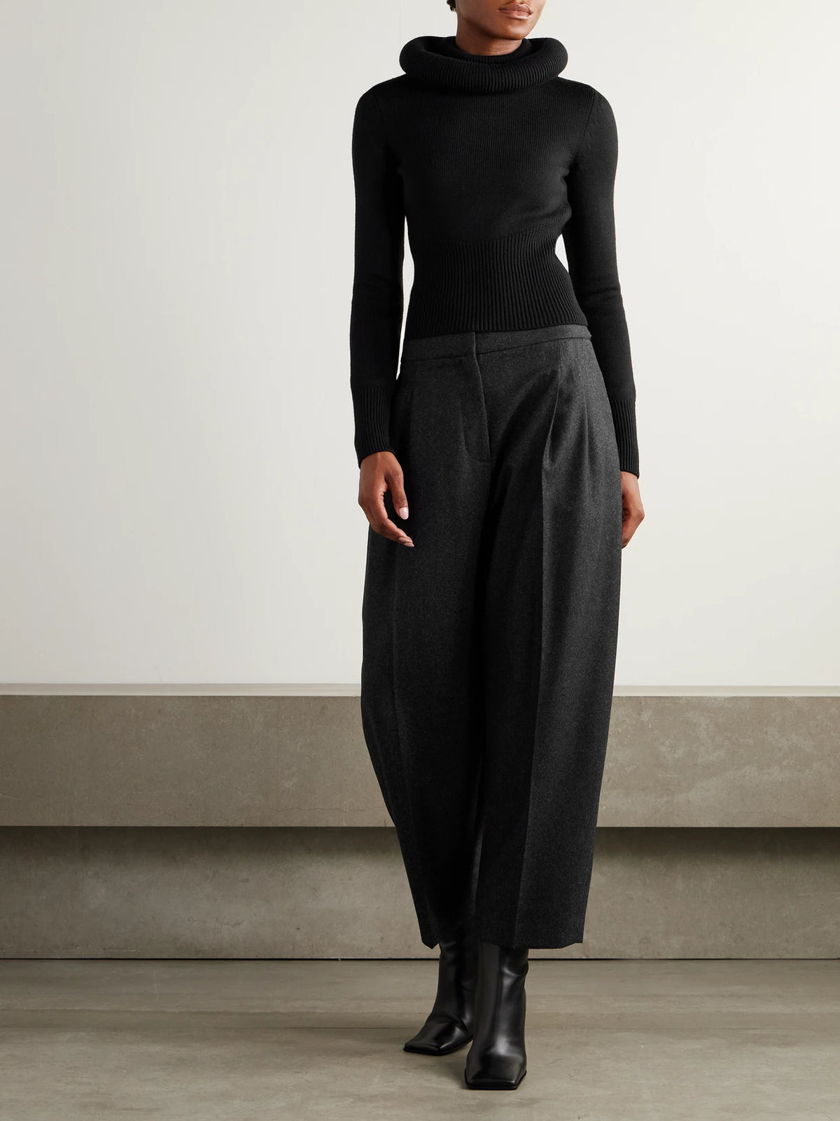 Image of a model wearing Outerwear. Product name - Wool Sweater in Black colour by brand - Alaïa